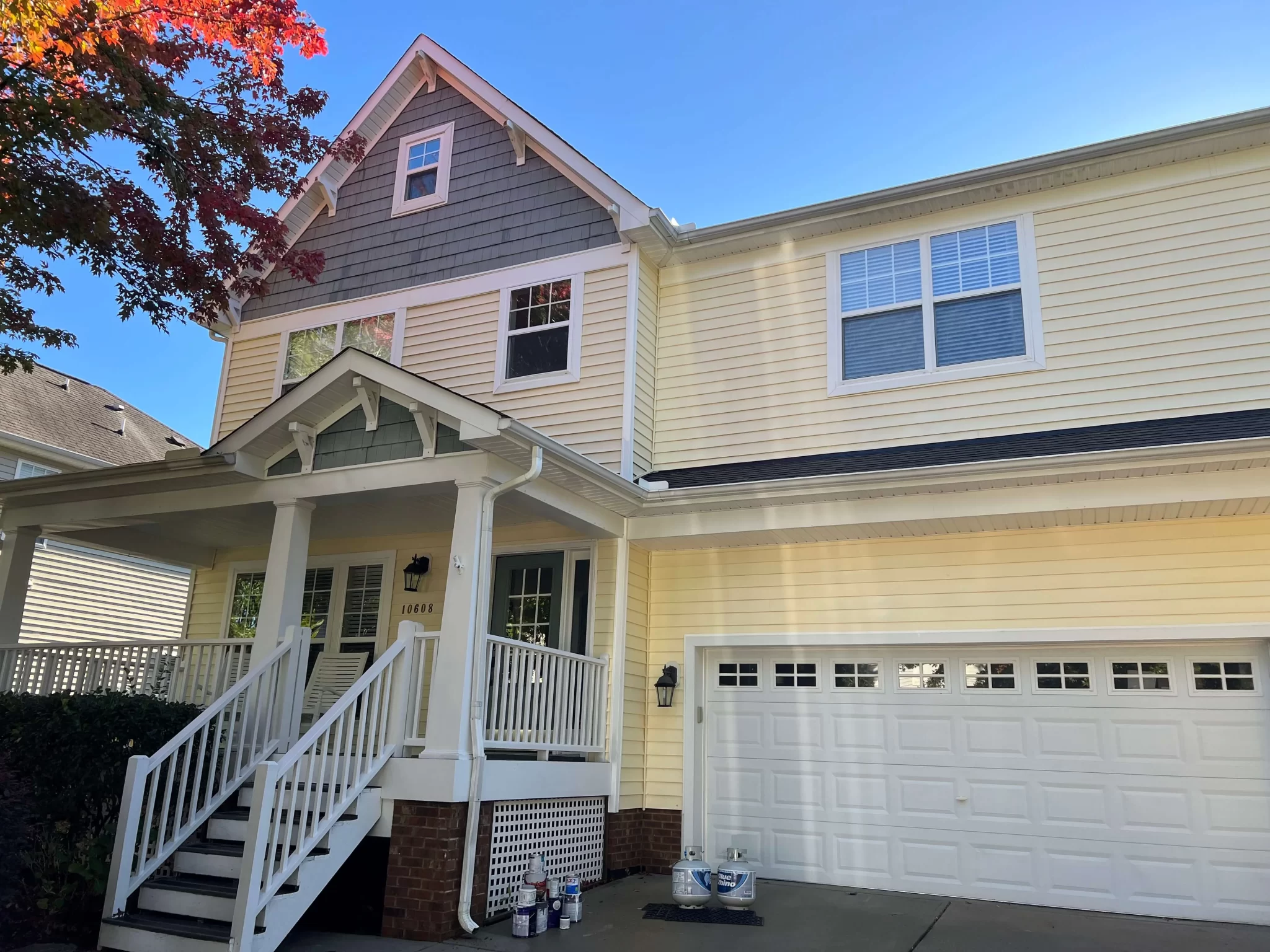 Clean house exterior after power washing service